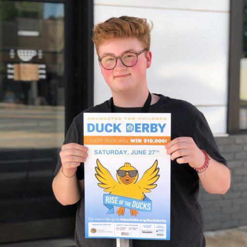 Ethan Jordan selling ducks for Advocates for Children Duck Derby